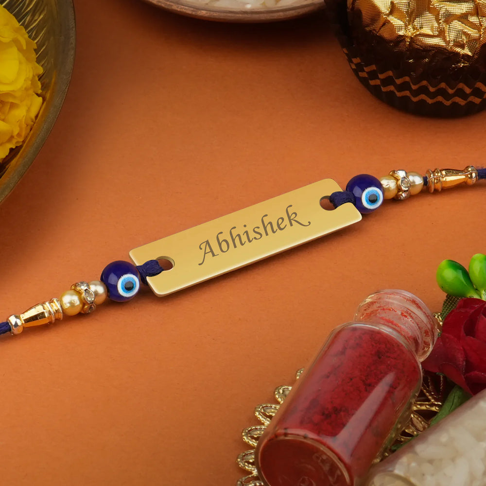 Beautiful Rakhi featuring a protective Evil Eye charm, personalized with your brother's name.