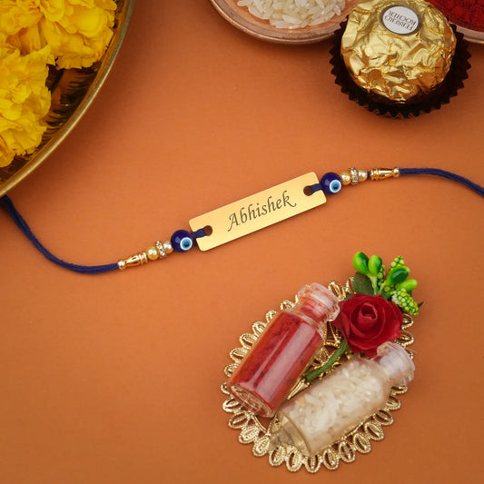 Close-up of a Personalized Evil Eye Rakhi with "[Brother's Name]" clearly engraved. (Zestpics)