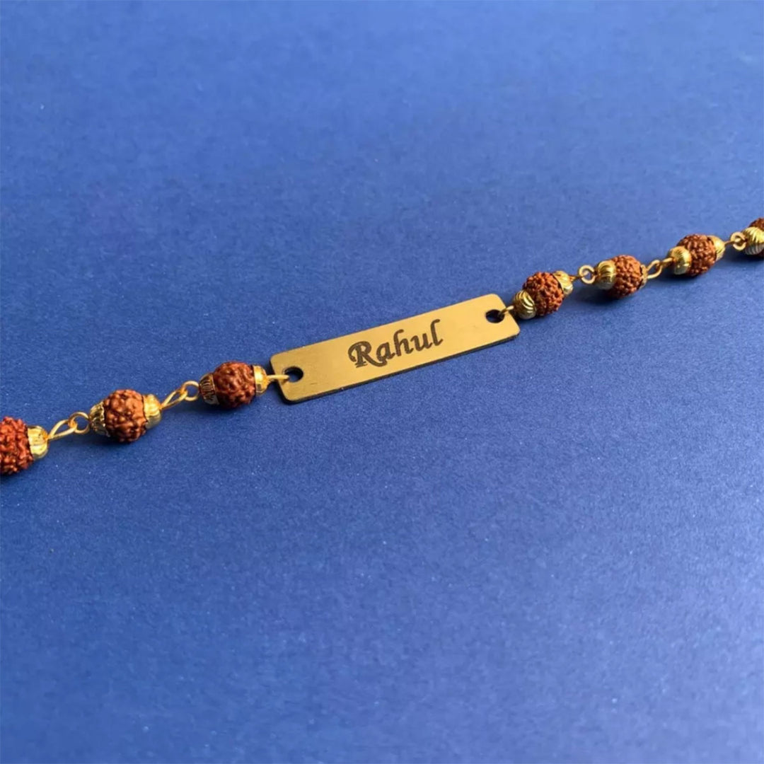 Elegant Rudraksha Rakhi with custom name engraving for a special Raksha Bandhan.