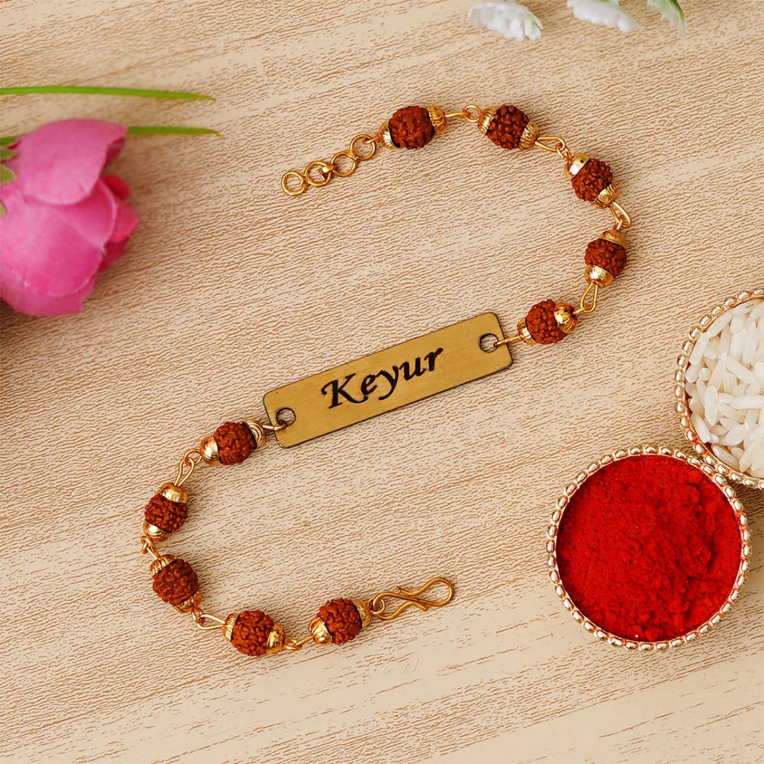 Show your brother you care with a personalized Rudraksha Rakhi, a symbol of protection.